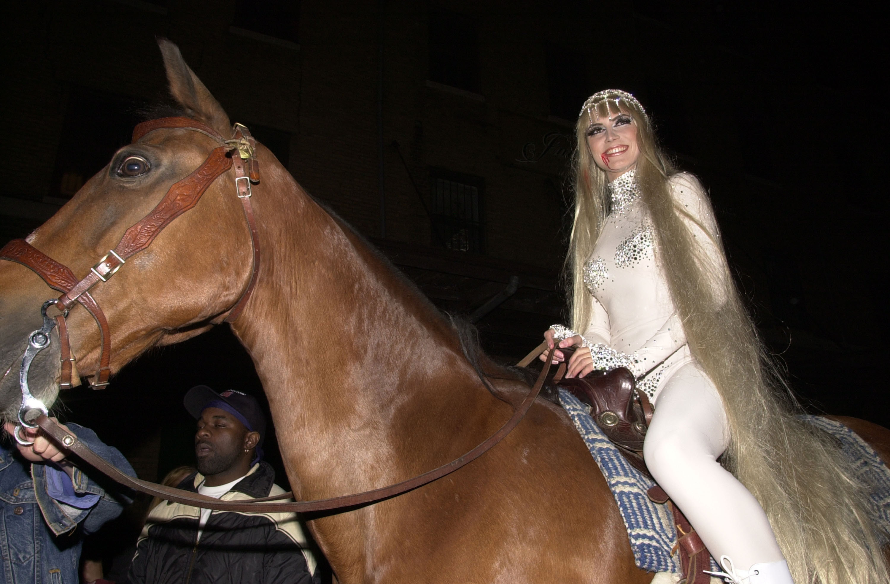 Heidi Klum in a bodysuit on a horse. Horse looks scared!