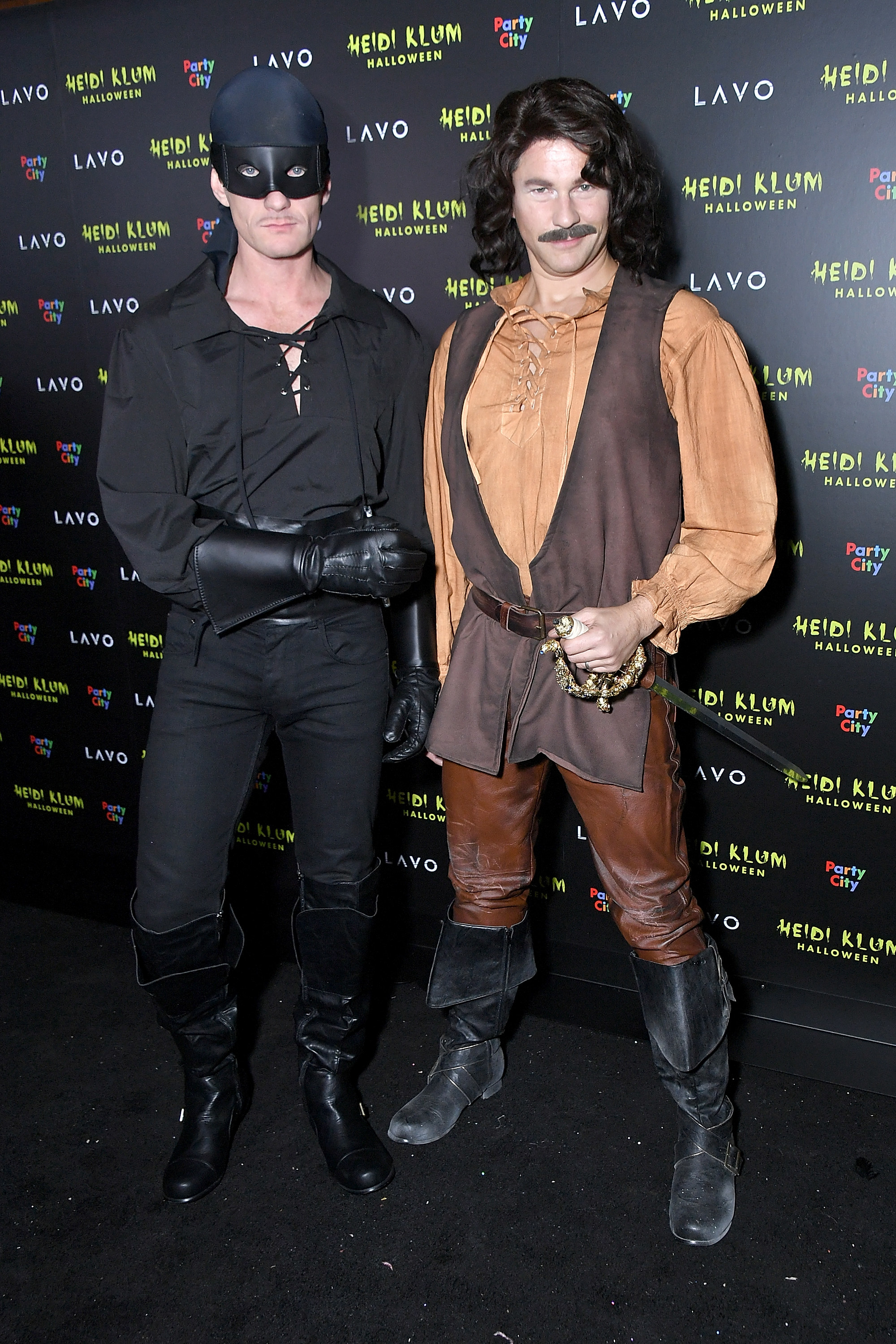 Two men dressed in costumes. 