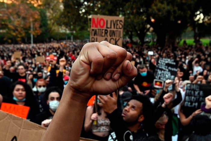 A hand raised in the Black Lives Matter Symbol at a protest