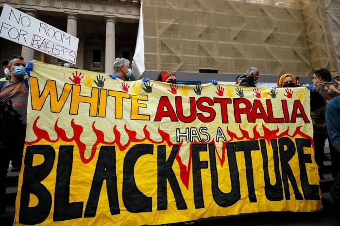 Protesters at a Black Lives Matter rally in Australia holding up a banner that says &quot;White Australia has a Black future&quot;