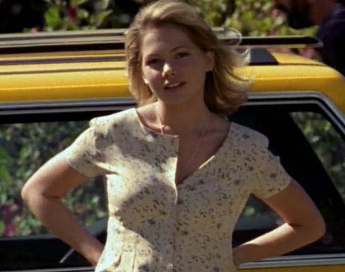 Jen walking away from a yellow cab