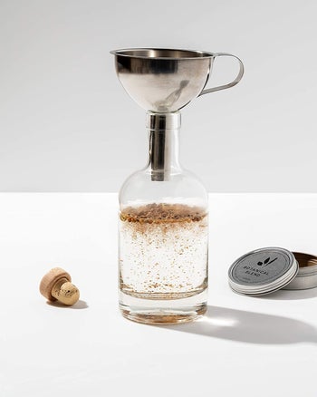 Bottle of the gin and equipment from the kit used to make gin