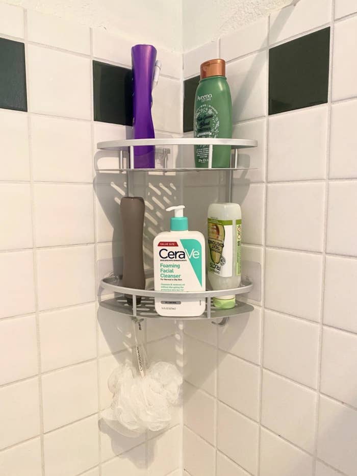 Reviewer photo of the shelf holding toiletries and a loofah