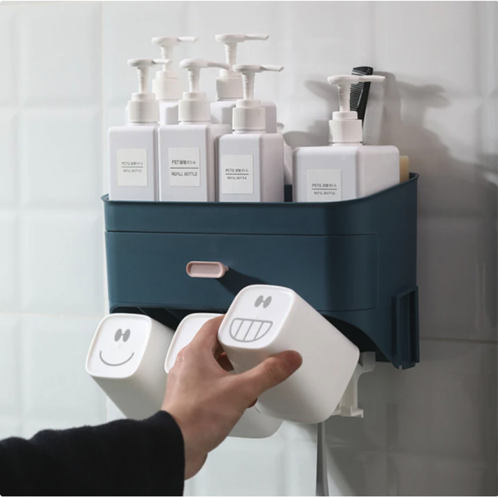 Hand grabbing one of the cups, which has a smiley face printed on its base