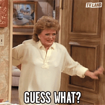 A GIF of a person smiling and saying guess what