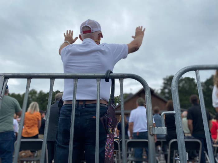 An attendee stands with his arms raised at an Evangelicals for Trump event in Georgia last month