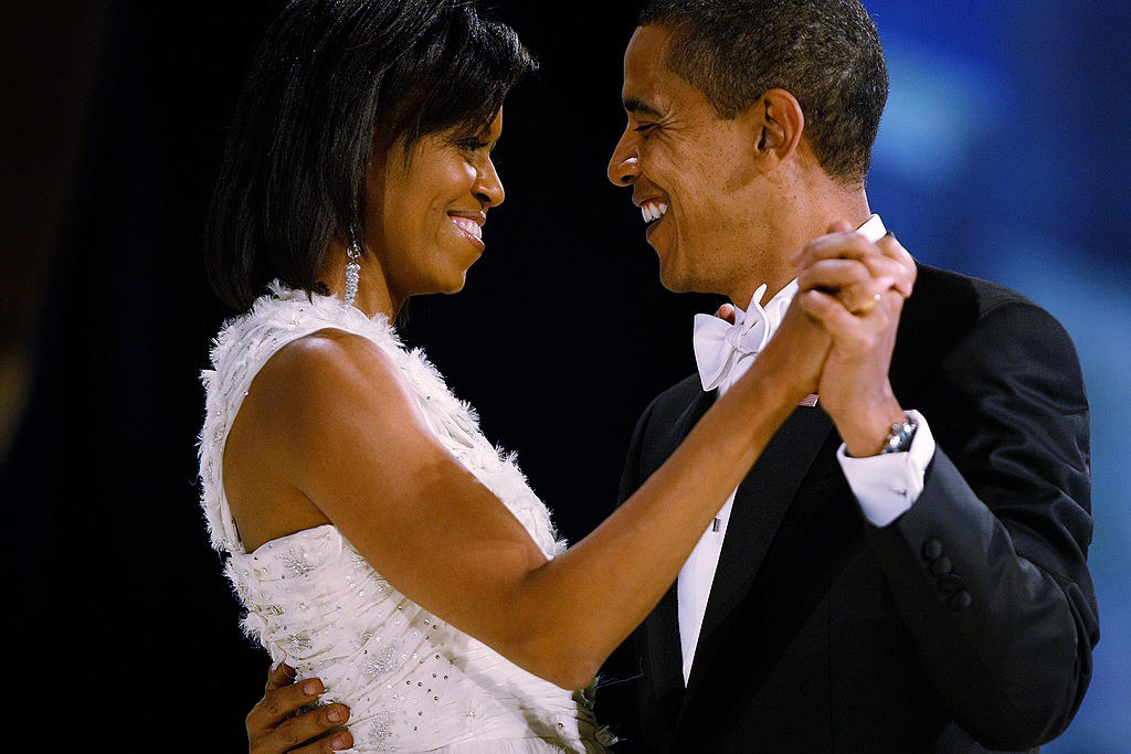 Michelle and Barack smiling and dancing together