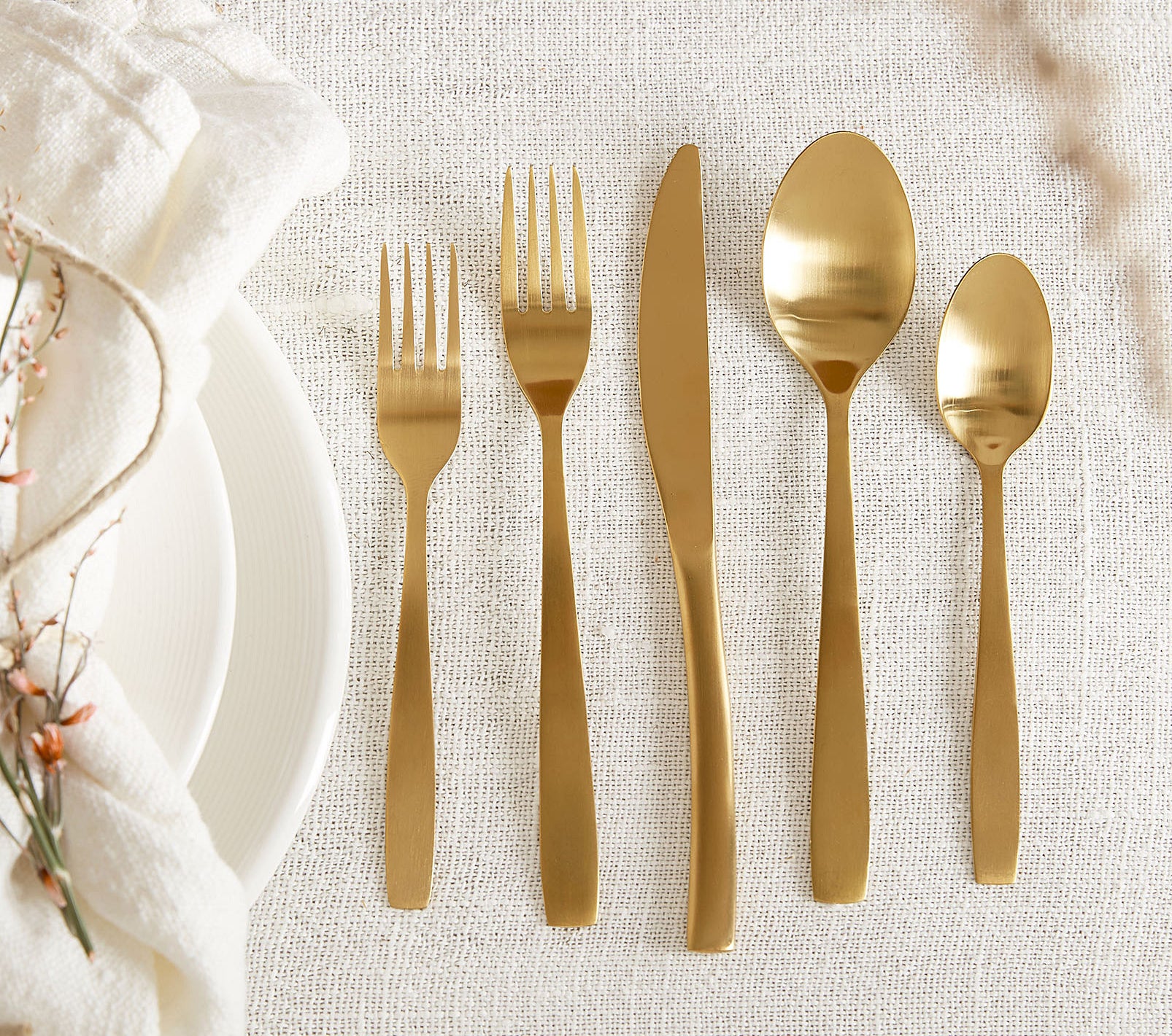 A set of gold cutlery on a table