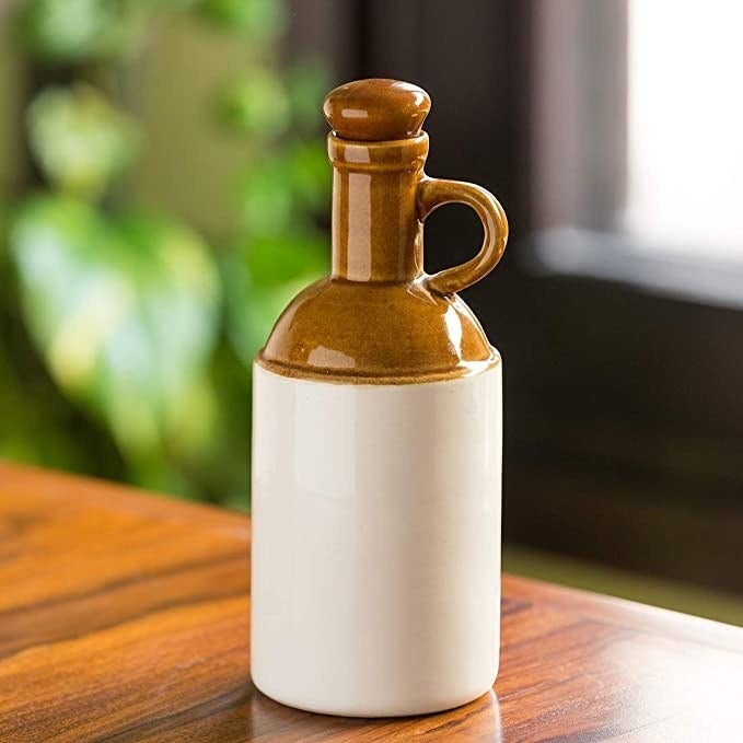 Brown and white oil dispenser.