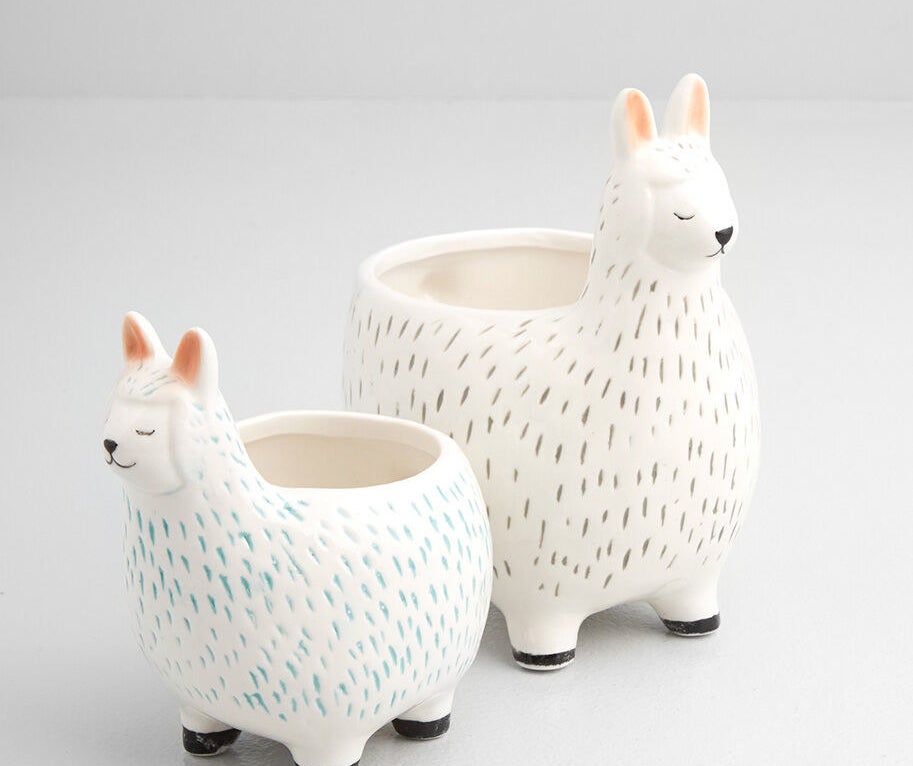 A pair of ceramic pots in the shape of llamas