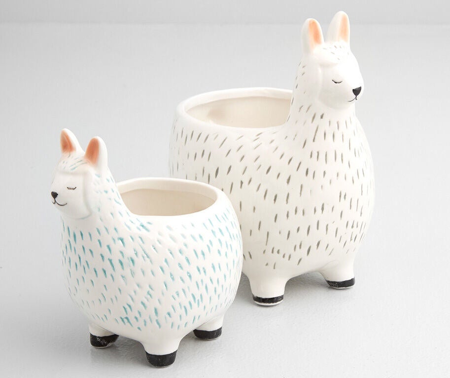 A pair of ceramic pots in the shape of llamas