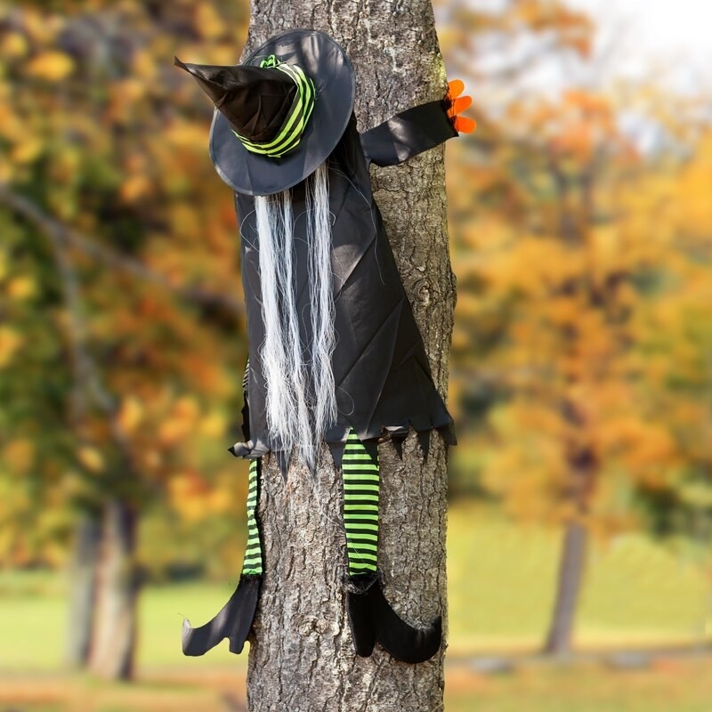 The witch figurine placed on a tree