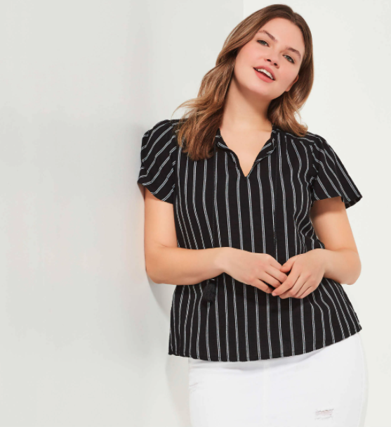 A model wearing a short-sleeves black shirt with pinstripes