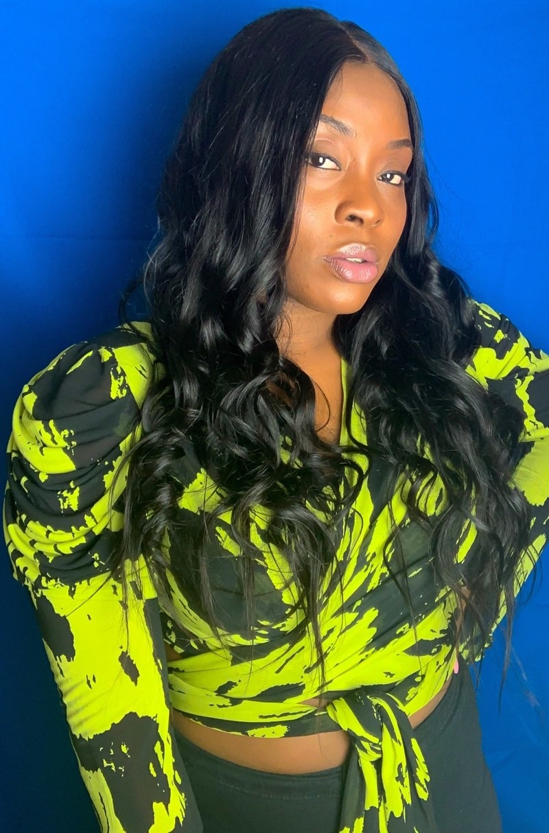 reviewer wearing V-neck black and green sleeved wrap top