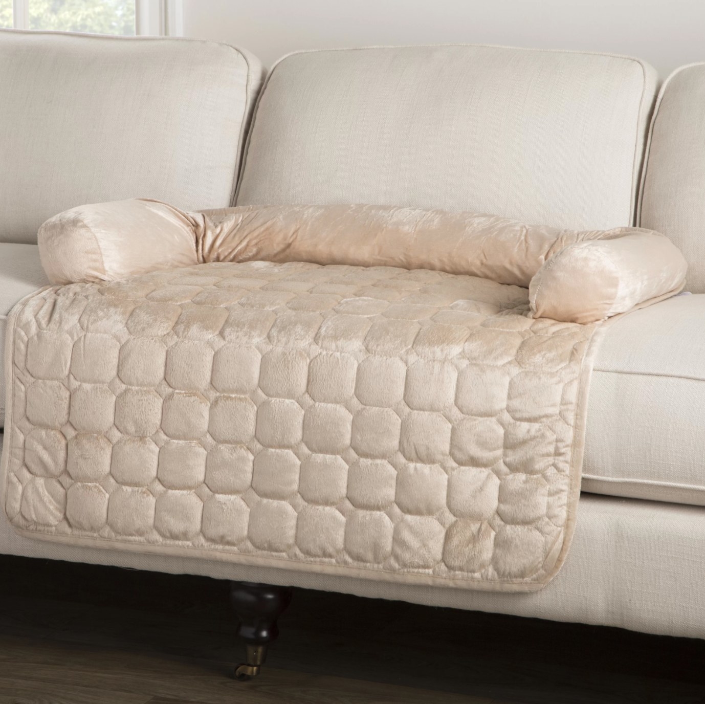 The furniture protector in beige on a white couch