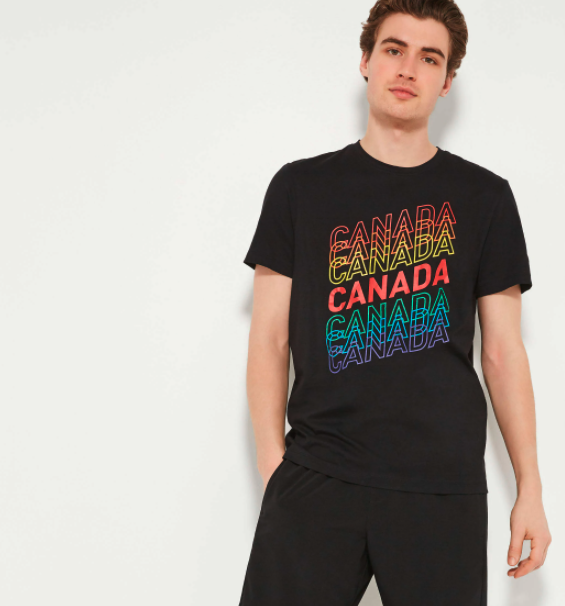 A model wears a black T-shirt with the word Canada written across it several times in different colours