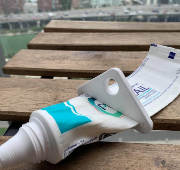 A close up of the toothpaste squeezer on a tube