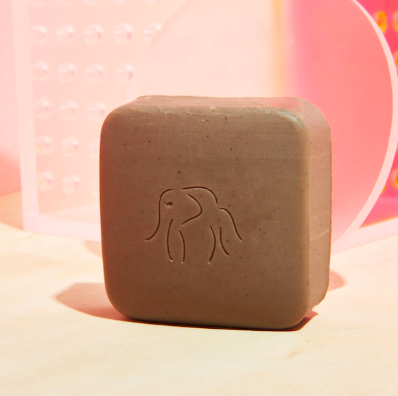 A close up of the exfoliating bar on a vanity