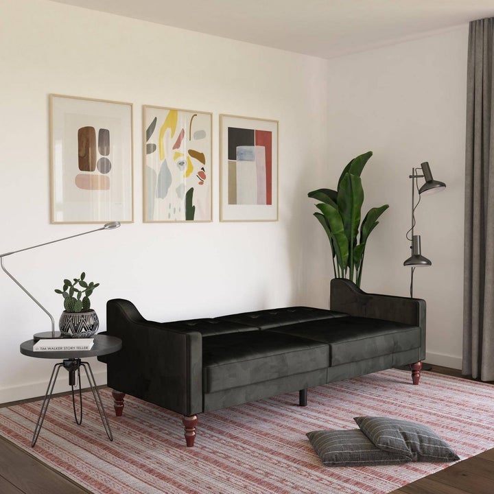 black futon with the back down to create a bed