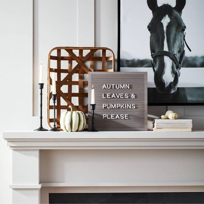 wooden letterboard on a mantle