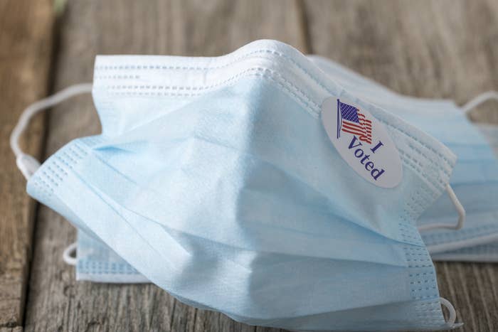 A face mask with an I Voted sticker