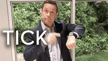 GIF of a General Hospital actor pointing to his watch as the words Tick Tock appear on screen