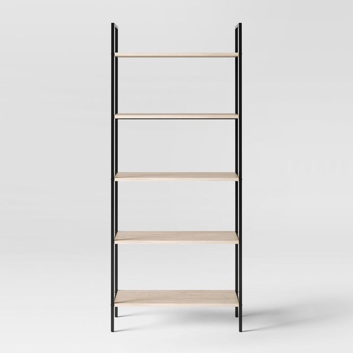 ladder bookshelf with black sides and wooden shelves