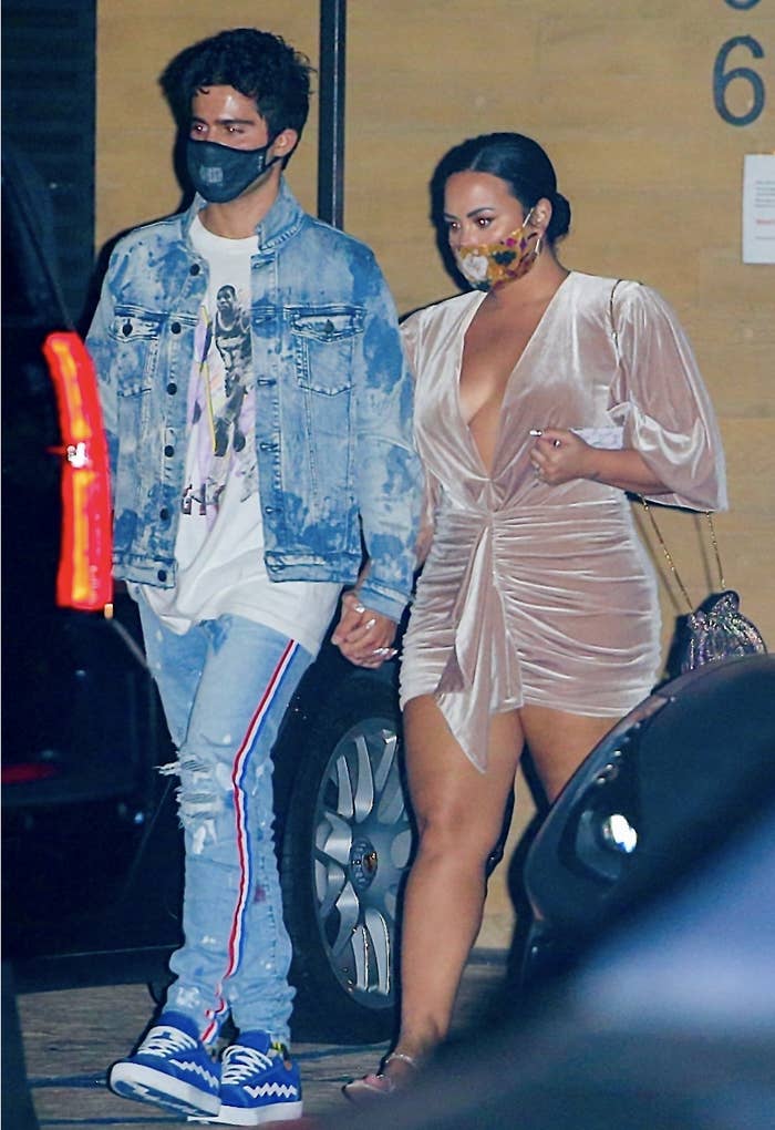 Demi and Max holding hands and walking together