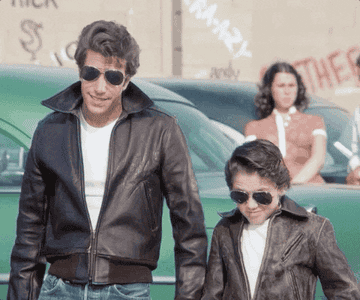 Henry Winkler as  Arthur &#x27;Fonzie&#x27; Fonzarelli and a small child dressed in matching leather jackets and sunglasses in the show &quot;Happy Days.&quot;