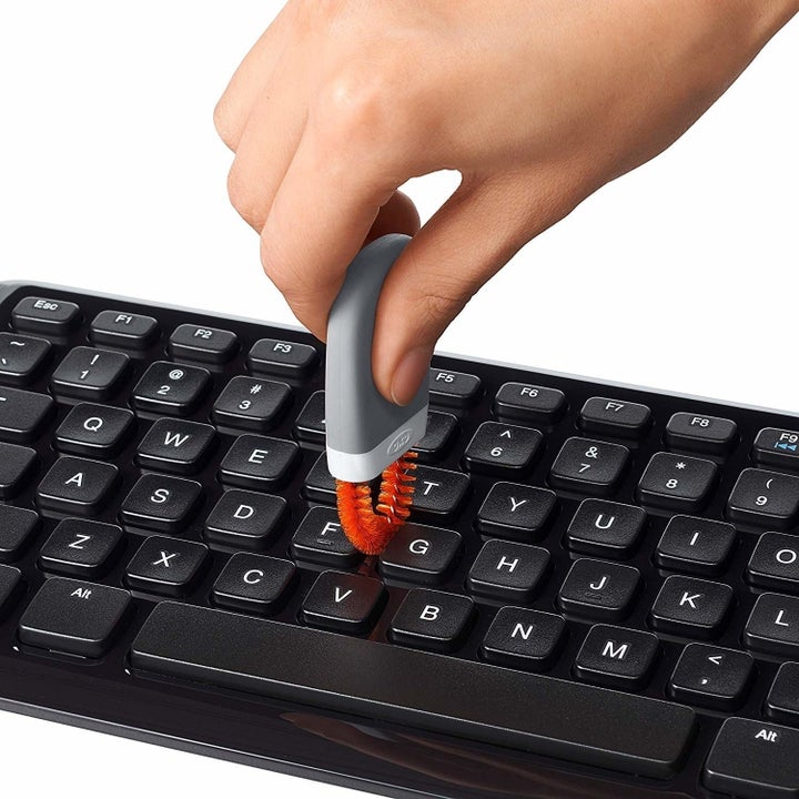 A person using the keyboard cleaner