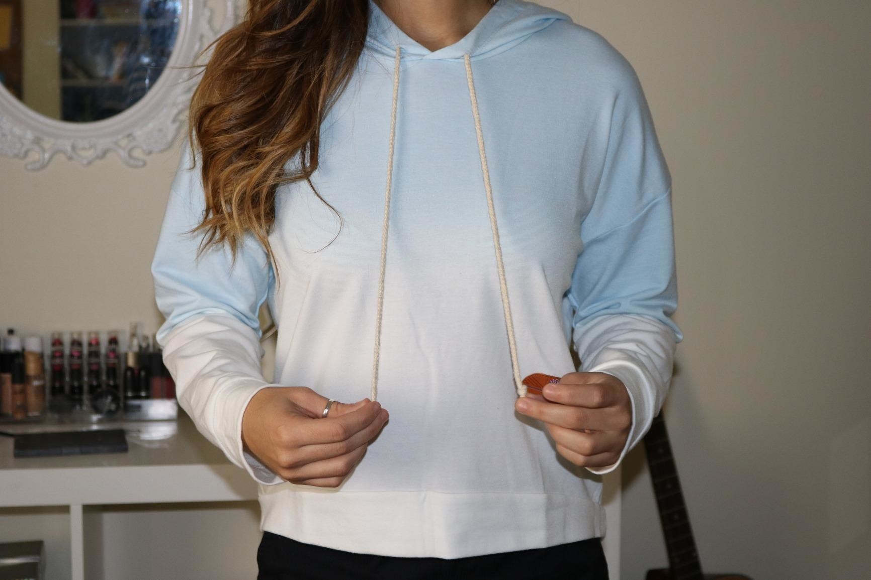 reviewer wearing blue ombre hoodie 