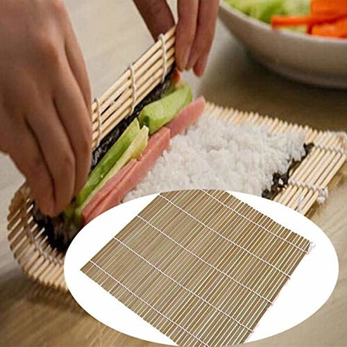 A hand rolling a sushi roll with the bamboo mat.