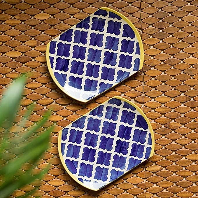 Blue serving plates with a white pattern on them.