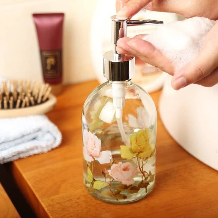 A soap dispenser decorated with flowers