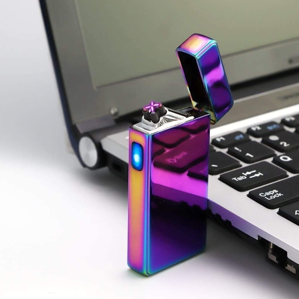 An electric lighter beside a laptop