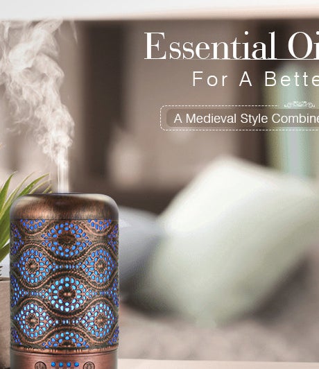 An essential oil diffuser with a pretty hammered pattern on a table