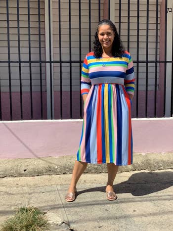 A different reviewer wearing the dress in multi-colored stripes