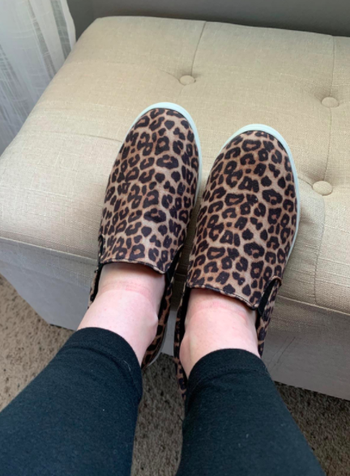Reviewer wears brown leopard-print slip-on sneakers with black leggings