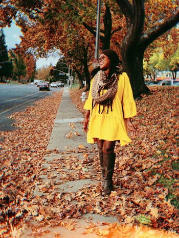 A different reviewer wearing the dress in yellow with a scarf