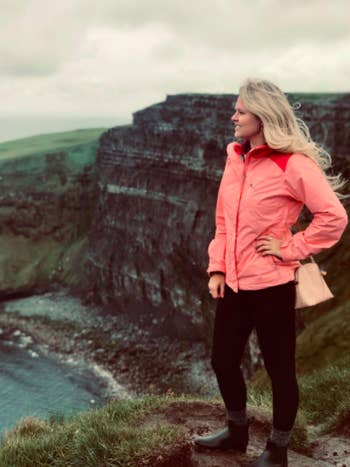 Reviewer wears same rain boots while walking along cliffs in Ireland