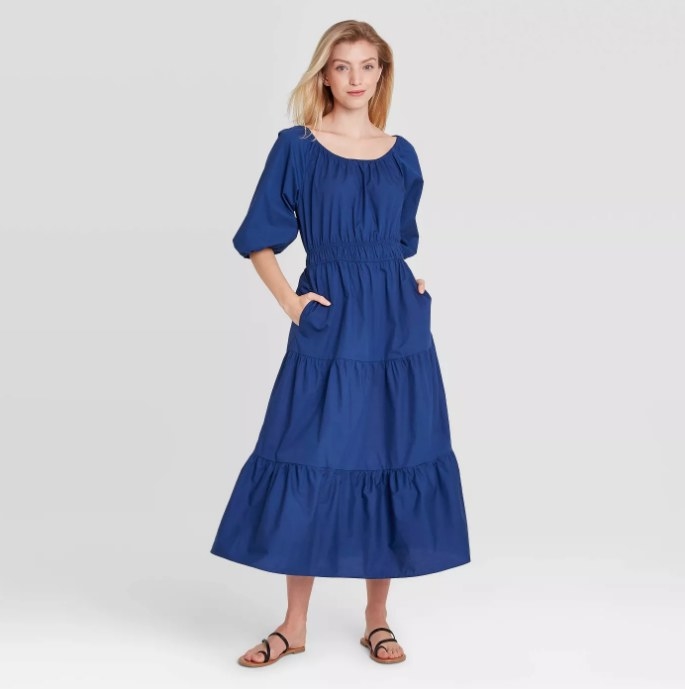 Model wearing blue tiered puff dress
