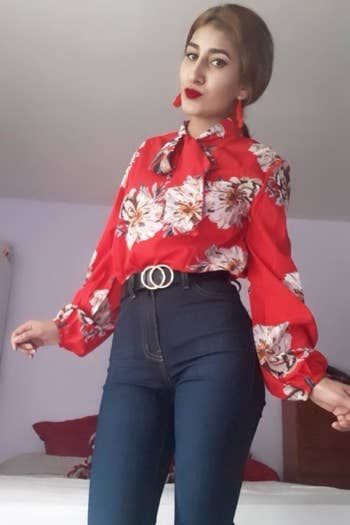 A reviewer wearing the red floral version tucked into high-waisted jeans