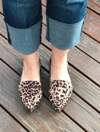 Reviewer wears cheetah-print loafer flats with cuffed light blue denim