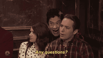 a gif of tom hanks as david s pumpkins scaring two people saying &quot;any questions?&quot;