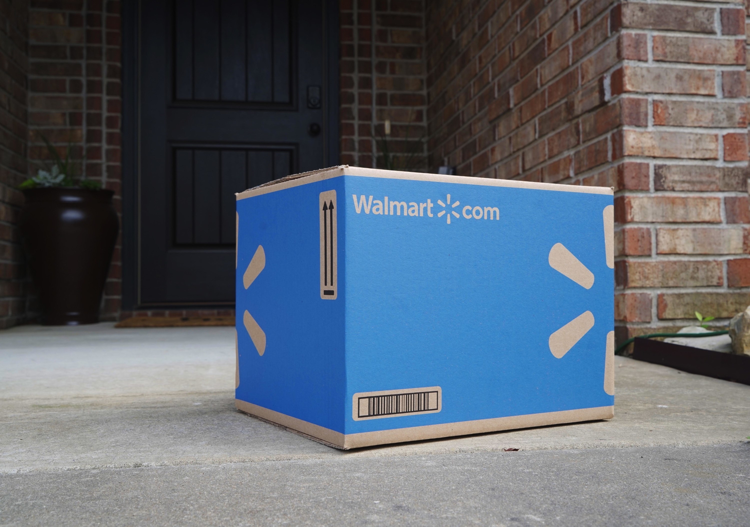 Blue cardboard Walmart delivery box on doorstep 
