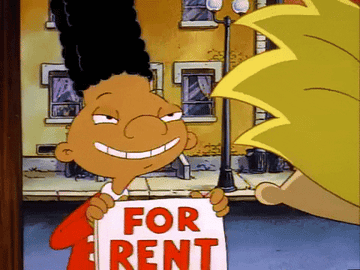 Gerald holding up a &quot;For Rent&quot; sign and grinning