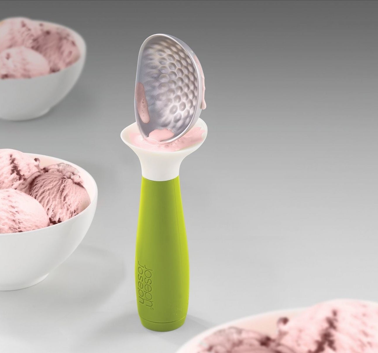 The ice cream scoop, which a wide plastic cuff that flares out below the scoop area, to catch ice cream drips