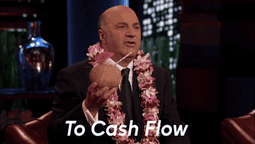 A gif of Kevin O&#x27;Leary from &quot;Shark Tank&quot; raising a coconut drink and saying, &quot;To Cash Flow&quot; 