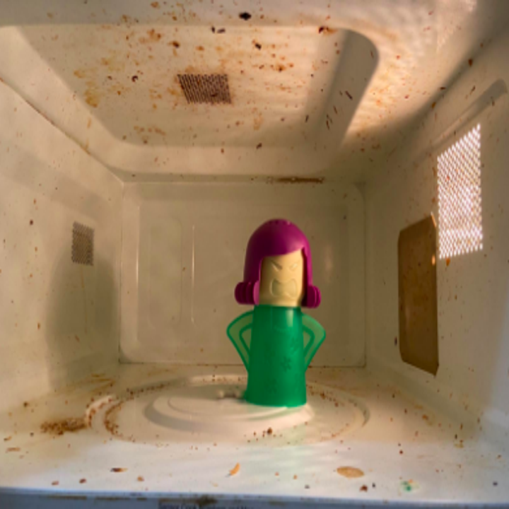 Messy microwave with cleaner inside