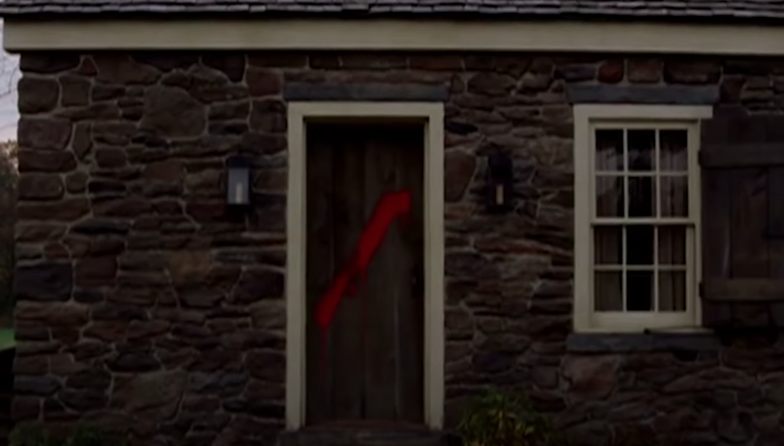 Red paint splashed on Lucius' door after he left the village
